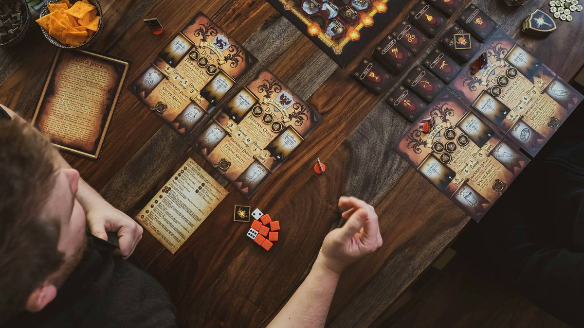 Top-down view of a man playing a board game.